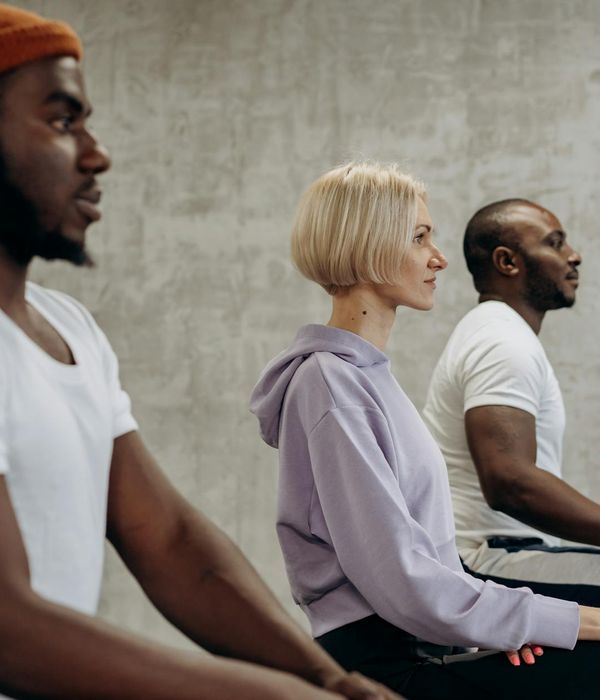 Group of diverse people of different ages practicing yoga together.